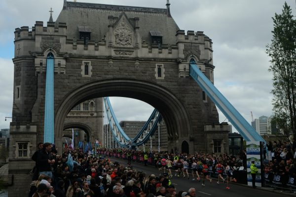 Runners running across tower bridge during a London running event